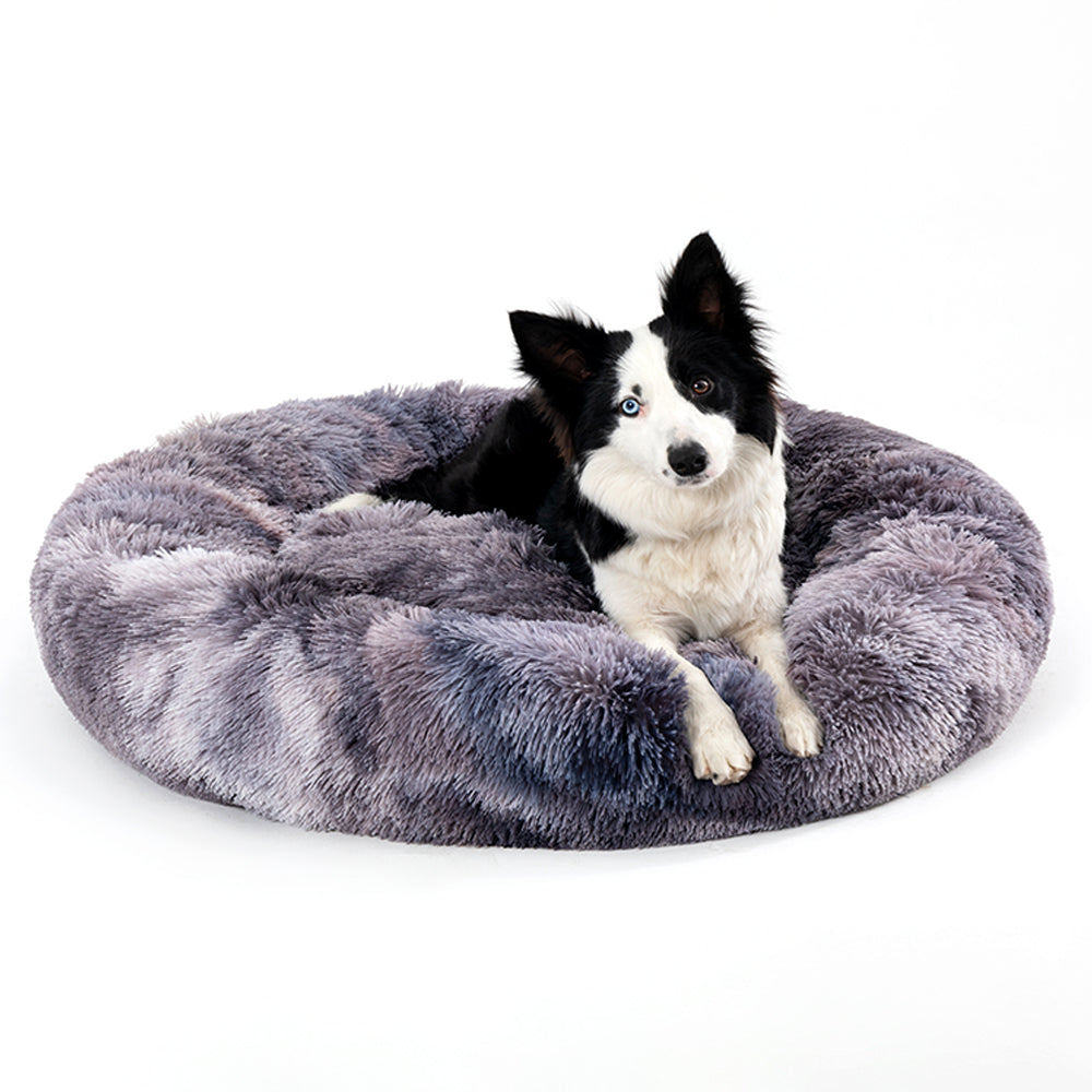 Fluffy round donut-shaped calming pet bed in cream plush, cuddler style for dogs and cats