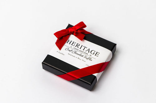 Chocolate truffle box with a red ribbon on a white background