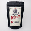 A black stand-up pouch of Maverick Chocolate Co. 65% Dark Drinking Chocolate, featuring a cream-colored label with a vintage hot air balloon illustration and red branding, set against a plain white background.