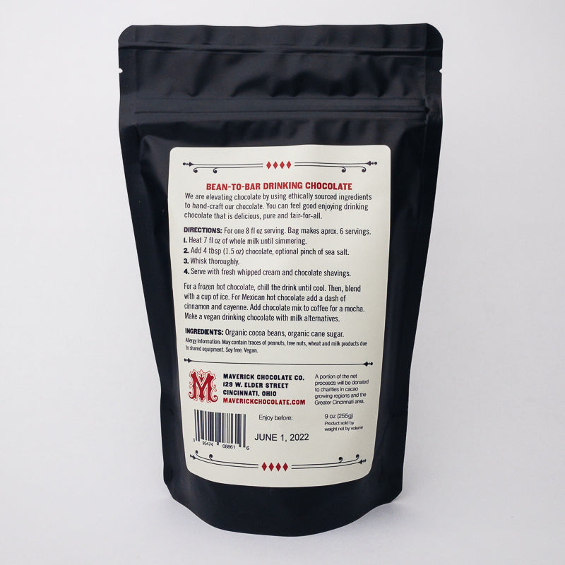 Black packaging of bean-to-bar drinking chocolate with white label on a light gray background