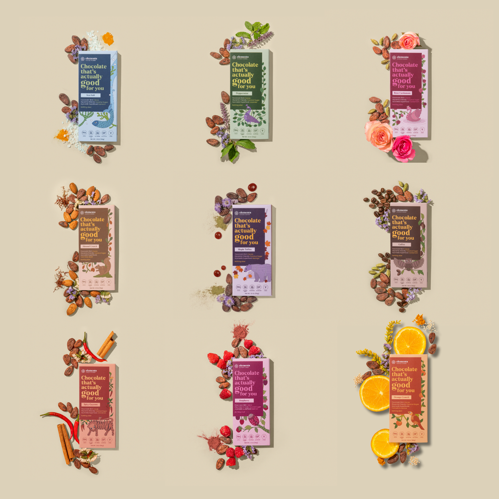 Nine chocolate bar packages arranged in a 3x3 grid on a warm beige background, each styled with decorative ingredients such as flowers, cinnamon sticks, citrus slices, and nuts. The packages feature different flavor/colorways including blue, green, pink, and brown tones, with readable text including 'Chocolate with.