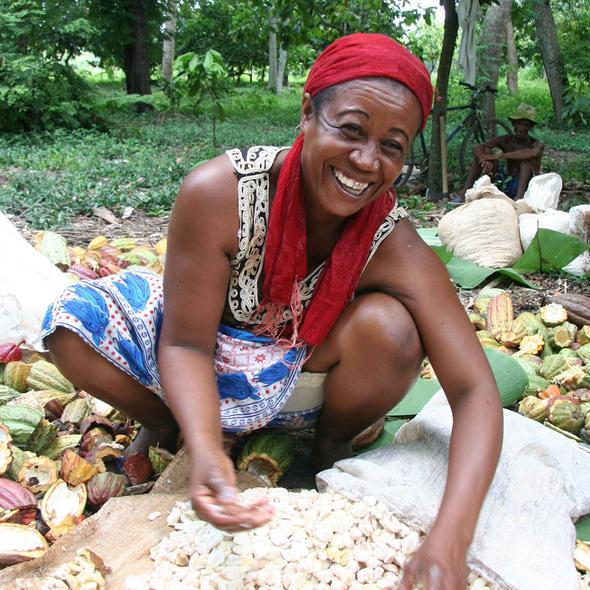 Woman processing cacao beans in a natural setting
