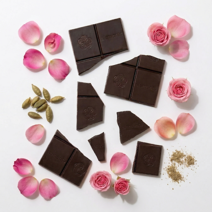 Dark chocolate bars with floral decorations on a white background