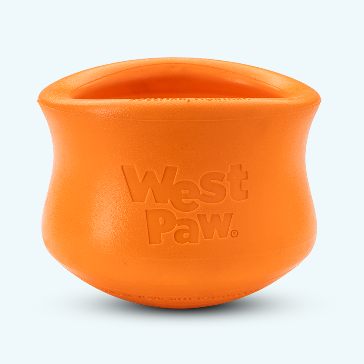 An orange West Paw rubber dog toy with embossed branding, shown on a clean white background.